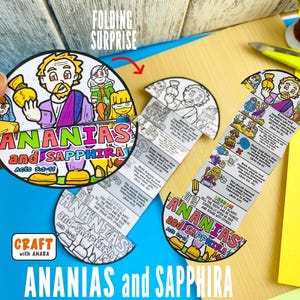May include: A colorful, illustrated craft project labeled "ANANIAS and SAPPHIRA" with text from Acts 5:1-11. The design features a circular, folding surprise element with cartoon figures and text. The craft is on a wooden surface with craft supplies.