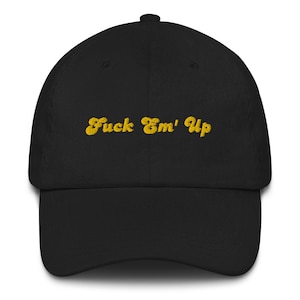 Puede incluir: Una gorra de béisbol negra con una frase bordada en amarillo "Fuck Em' Up" en la parte delantera.