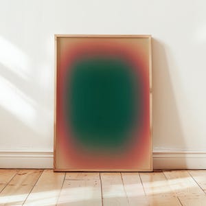 May include: A framed abstract art print with a gradient of pink, orange, and green colors. The print is in a wooden frame.