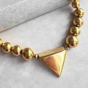 Colar gargantilha modernista com contas de metal polido dourado e peça central NAPIER Vintage Ad Piece, anos 70, assinado