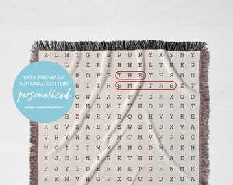 May include: A beige woven throw blanket with a word search puzzle featuring the name "Smiths". The puzzle is printed in black text on a white background. The blanket has a fringe border in various colors. The text "100% Premium Natural Cotton Personalized Word Search Blanket" is printed on the blanket.