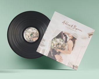 May include: A black vinyl record with a white label featuring a wedding photo of a couple kissing. The record cover is white with a brown text overlay that reads "Adeline & Benjamin to the moon and back".