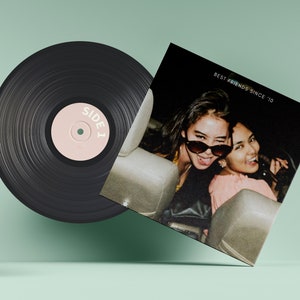 May include: A black vinyl record with a pink label that says "SIDE 1". The record is next to a black and white photo of two friends in a car. The photo has the text "BEST FRIENDS SINCE '10" at the top.