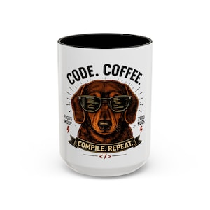 May include: A white ceramic mug with a black interior featuring a brown dachshund wearing glasses with code reflected in the lenses. The text reads CODE. COFFEE. COMPILE. REPEAT. FOCUS MODE. ZERO BUGS with a small code bracket symbol at the bottom.