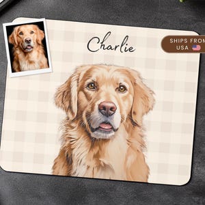 May include: A personalised mouse mat with a detailed illustration of a Golden Retriever. The mat has a beige and white checked pattern, with the name "Charlie" in cursive. A small photo of the dog is in the upper left corner.