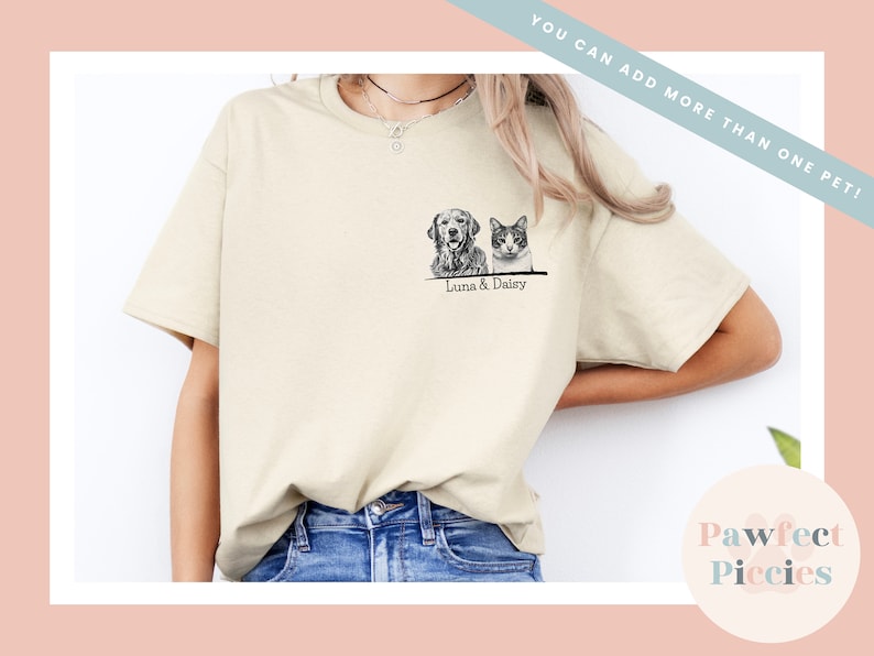 May include: A beige t-shirt with a black and white illustration of a dog and cat. The text "Luna & Daisy" is printed below the illustration.