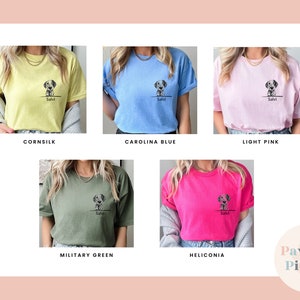 May include: Five different color t-shirts with a graphic of a dog and the name "Salvi" printed on the front. The colors are cornsilk, carolina blue, light pink, military green, and heliconia.