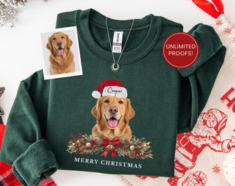 May include: Dark green sweatshirt featuring a golden retriever wearing a Santa hat with the name "Cooper". The design includes a Christmas wreath and the text "MERRY CHRISTMAS". A small photo of the dog is on the upper left.