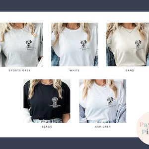 May include: Five different color t-shirts with a graphic of a dog peeking over the top of a line with the name "Salvi" underneath. The colors are sports grey, white, sand, black, and ash grey.