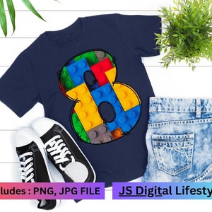 Könnte beinhalten: Ein marineblaues T-Shirt mit einer bunten Zahl Acht aus Lego-Steinen. Der Text "includes: PNG, JPG FILE" befindet sich am unteren Rand des Bildes. Der Text "JS Digital Lifestyle" befindet sich am unteren Rand des Bildes.