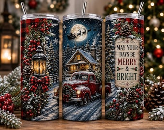 May include: Three cylindrical tumblers with metal straws featuring a winter scene with a red truck, a cabin, a full moon with Santa's sleigh, and a lantern. The text reads: MAY YOUR DAYS BE MERRY & BRIGHT. The design includes pine branches and berries.