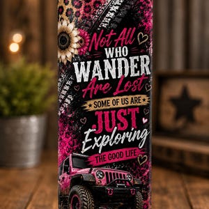 May include: A cylindrical stainless steel tumbler with a metal straw, featuring a pink leopard print background, a sunflower, and a pink off-road vehicle. The text reads: Not All WHO WANDER Are Lost SOME OF US ARE JUST Exploring THE GOOD LIFE.