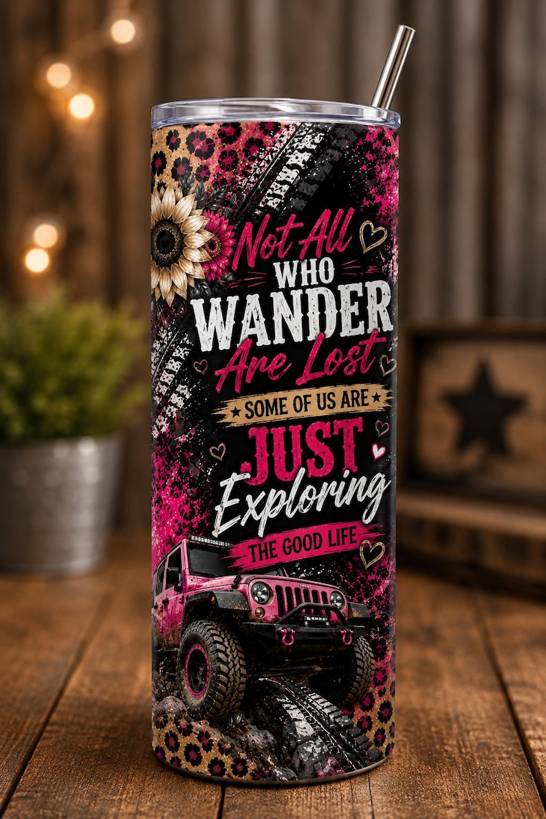 May include: A cylindrical stainless steel tumbler with a metal straw, featuring a pink leopard print background, a sunflower, and a pink off-road vehicle. The text reads: Not All WHO WANDER Are Lost SOME OF US ARE JUST Exploring THE GOOD LIFE.