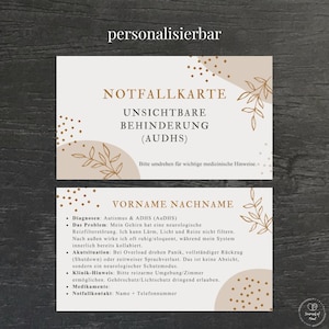 Op de afbeelding: Een beige en witte kaart met de tekst "NOTFALLKARTE UNSICHTBARE BEHINDERUNG (AUDHS)" en "VORNAME NACHNAME". De kaart bevat een bloemmotief en de woorden "personalisierbar".