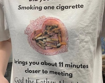 May include: White t-shirt with the text "Did you know? Smoking one cigarette brings you about 11 minutes closer to meeting God the Father Almighty." The shirt features a heart-shaped design filled with cigarette butts.