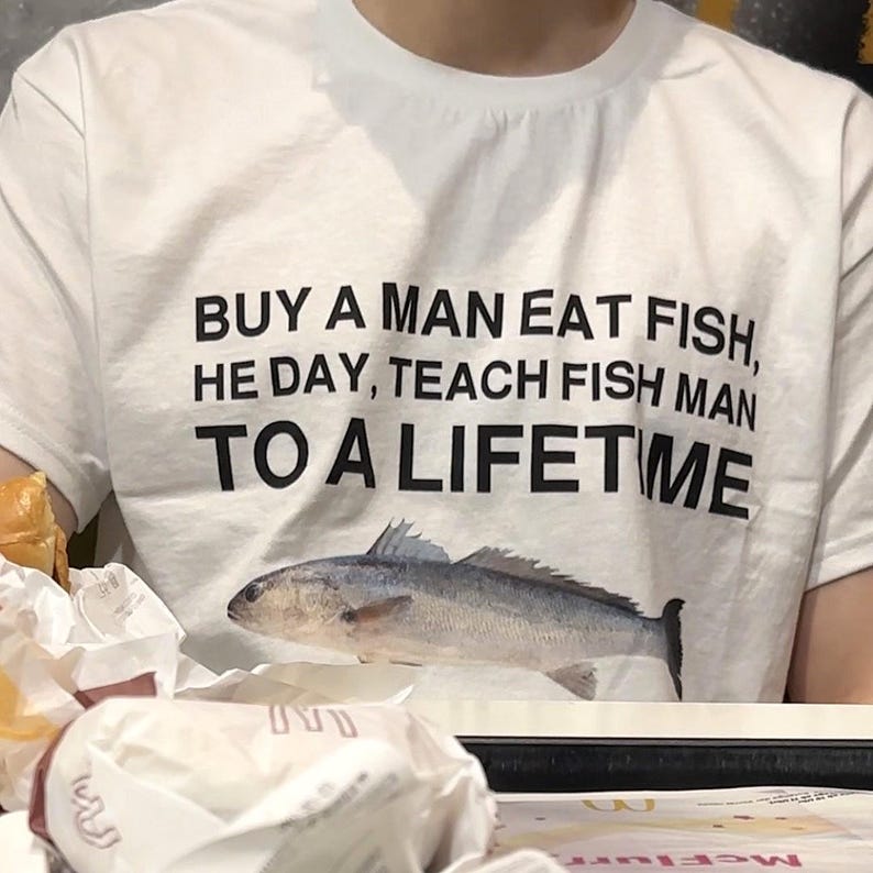 Buy a Man Eat Fish shirt Funny Meme Shirt Inappropriate Shirt Unhinged Shirt Weird Shirt Ironic Shirt Sarcastic Shirt Funny Gift Gen Z Shirt image 1
