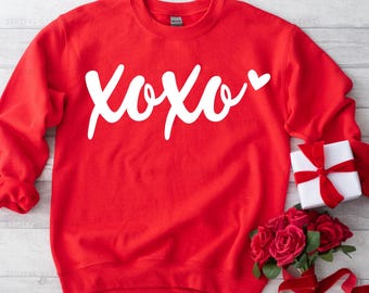 May include: Red sweatshirt with a white graphic that says "XOXO" with a small heart.