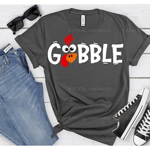 May include: A dark gray t-shirt with a white turkey graphic and the word "GOBBLE" in white letters.