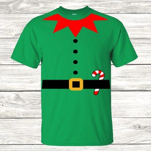 May include: Green short-sleeved t-shirt with a red collar, black belt, and a candy cane graphic. The shirt is designed to look like an elf costume.