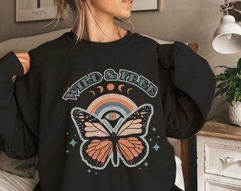 May include: Black sweatshirt with a graphic print of a butterfly with a rainbow and the text "WILD & FREE".