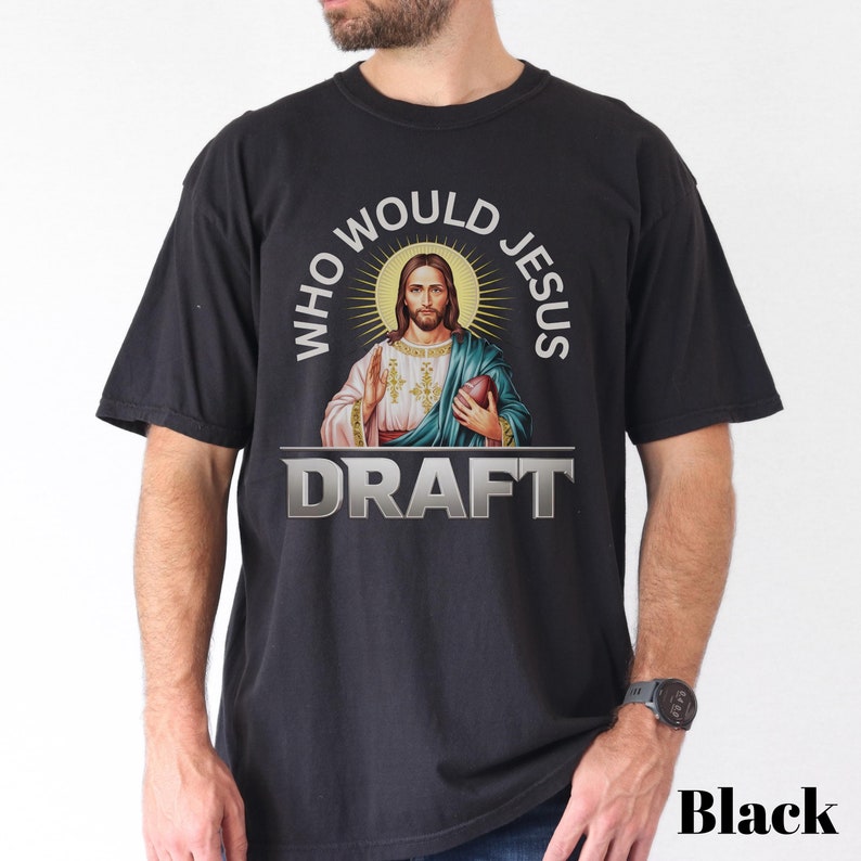 May include: Black t-shirt with a graphic of Jesus holding a football and the text "Who Would Jesus Draft".