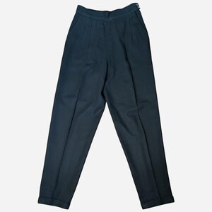 May include: Dark navy blue high-waisted trousers with pleats and a button closure. The pants have a tailored fit and cuffed hems. A classic style for a polished look.