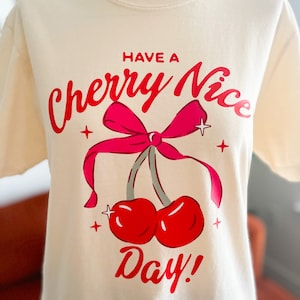 Fun Bow Detail Shirt Red Cherry Bow Tshirt Retro Charm Coquette Short Sleeve Tee with Cherry Bow Detail Perfect Gift Idea Unique Gift Idea