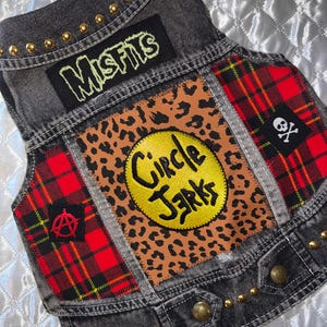 Large Punk Rock Dog Battle Vest: Embroidered Circle Jerks and Misfits Patches. Leopard Print and Red Flannel Side Panels. Gold Studs.