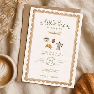 May include: A rectangular baby shower invitation card with a scalloped tan border. The text reads a little bean is brewing, please join us for Avery's baby shower, Sunday 25 April, 123 Sams Coffee Shop Savannah Georgia, RSVP to +123-456-7890.