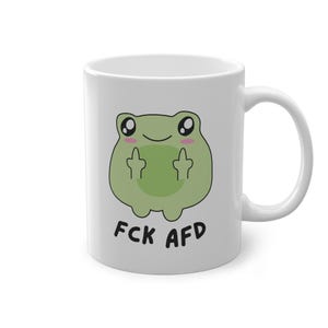 May include: White ceramic mug featuring a cartoon green frog giving the middle finger. The text "FCK AFD" is printed below the frog.
