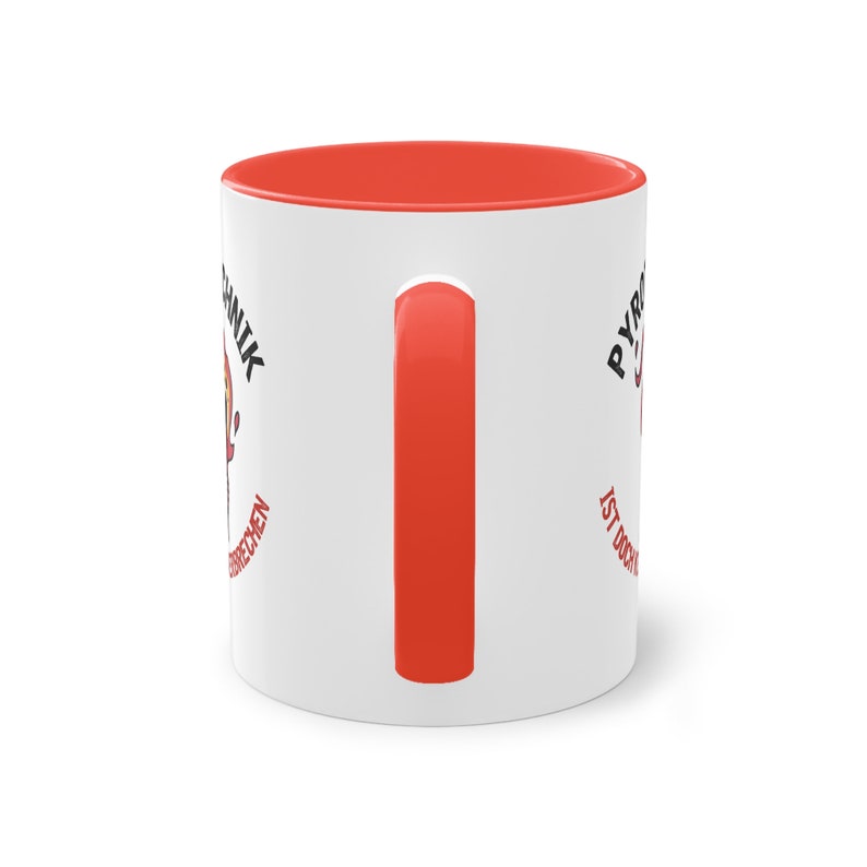 May include: White ceramic coffee mug with a red rim and handle. The mug has a black and red graphic on one side that says "Pyromanik ist doch kein Verbrechen" and a black and red graphic on the other side that says "Pyromanik".