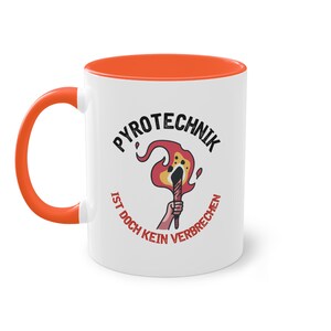 May include: White ceramic coffee mug with an orange rim. The mug features a black and red illustration of a burning torch with the text "PYROTECHNIK IST DOCH KEIN VERBRECHEN" around it.