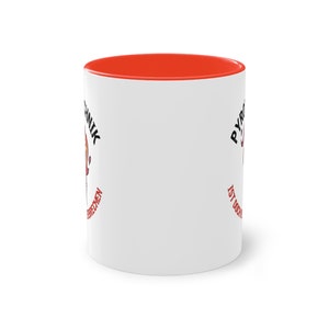 May include: White ceramic mug with a red rim. The mug has a black and red graphic with the text "Pyromanik ist doch kein Beruf, sondern eine Lebenseinstellung."