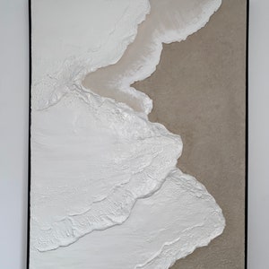 May include: Abstract painting with white and beige textured paint on a canvas. The white paint is layered and textured to create a wave-like effect. The beige paint is in the background and creates a contrast with the white paint.