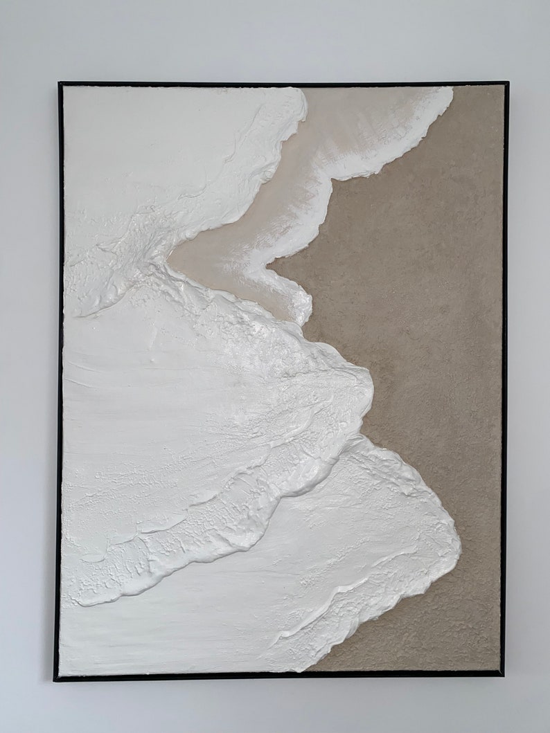 May include: Abstract painting with white and beige textured paint on a canvas. The white paint is layered and textured to create a wave-like effect. The beige paint is in the background and creates a contrast with the white paint.