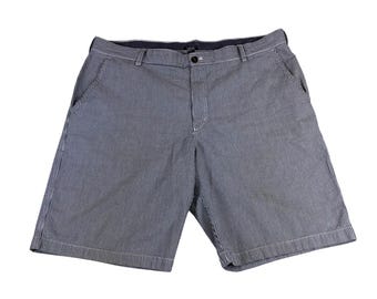 Pantalones cortos IZOD Saltwater para hombre, azul marino, blanco, con rayas verticales y parte delantera plana, talla 42.