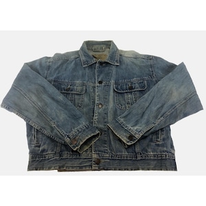 May include: A light blue denim jacket with a classic design. The jacket features a button-up front, two chest pockets, and two side pockets. The sleeves are long and have buttoned cuffs. The denim has a faded, worn look.