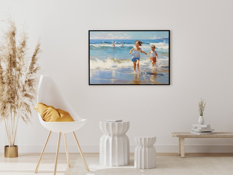 May include: A painting of two children running on a beach with waves crashing behind them. The painting is framed in black and hangs on a white wall.