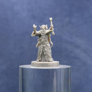 May include: A gray miniature figurine of a wizard with a long beard, holding a staff and wearing a robe. The wizard has his arms raised and is standing on a round base. The figurine is displayed on a clear, cylindrical stand.