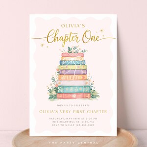 May include: A light pink invitation with gold text and a stack of colorful books. The text reads "Olivia's Chapter One" and "Olivia's Very First Chapter". Floral accents and event details are also included.