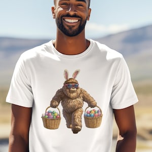 May include: A white t-shirt with a graphic of a brown furry creature wearing bunny ears and sunglasses, carrying two baskets of colorful Easter eggs.