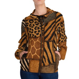 May include: A zip-up hooded jacket featuring a patchwork design of various animal prints including leopard spots, zebra stripes, and giraffe patterns in shades of brown, tan, and black. The jacket includes a black drawstring and two front pockets.