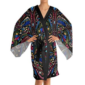 May include: A black kimono robe with a vibrant, detailed pattern. The design incorporates blue, red, and yellow elements, and a black tie belt. The robe has wide sleeves and a V-neck.