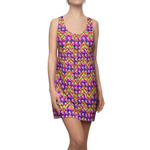May include: Sleeveless dress with a vibrant, geometric pattern in shades of pink, purple, blue, orange, and green. The dress has a scoop neckline and a fitted silhouette, perfect for a summer day.