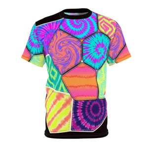 May include: A short-sleeve t-shirt featuring a vibrant, multi-coloured patchwork design. The pattern consists of various hexagonal and geometric shapes filled with bright tie-dye swirls, neon yellow stripes, and abstract pink and orange gradients.