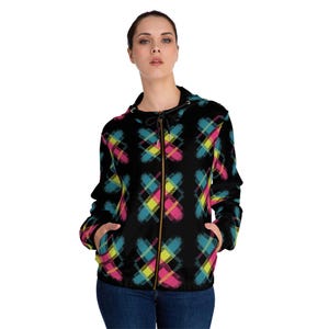 May include: Black zip-up hooded jacket with a colorful plaid pattern in pink, yellow, and teal. The jacket has a drawstring hood and two front pockets. The zipper is a bronze color.