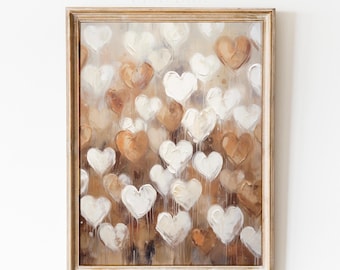 May include: Framed artwork featuring a collection of white and brown heart shapes against a neutral background. The painting has a textured, brushstroke appearance. The frame is a light, natural wood color. The text "meyaya." is in the top left corner.