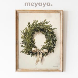 May include: A framed watercolor painting of a green wreath with a white satin bow. The wreath is on a cream background. The text "meyaya." is in the bottom right corner of the painting.