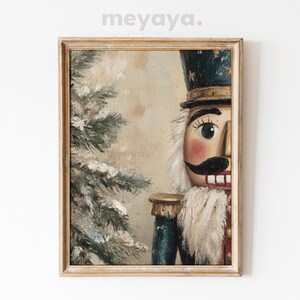 May include: A vintage-style painting of a wooden nutcracker with a blue and gold uniform, standing next to a snowy evergreen tree. The nutcracker has a painted face with rosy cheeks, a black mustache, and a wide smile.