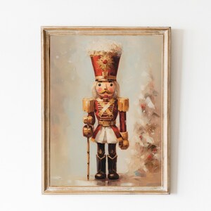 May include: A vintage-style painting of a wooden nutcracker soldier in a red and gold uniform, holding a staff. The nutcracker is standing in front of a snowy, white background with a Christmas tree in the background.